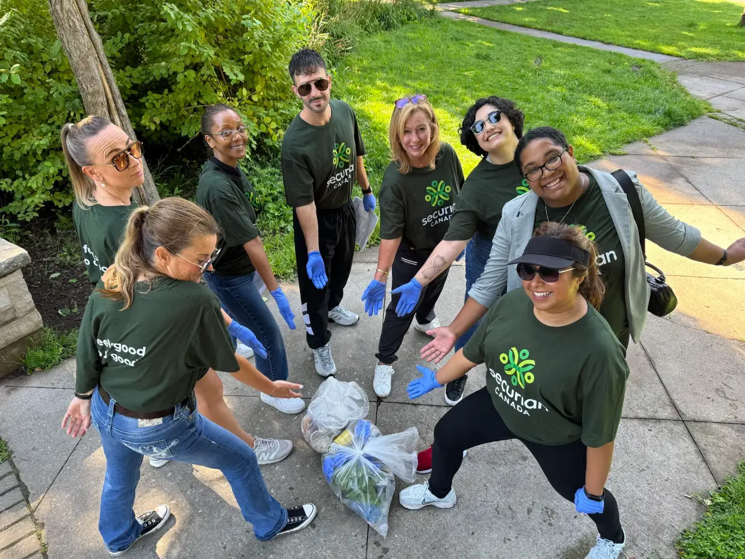 Securian Canada employee volunteers celebrate a successful park clean-up and their contribution to a cleaner community.