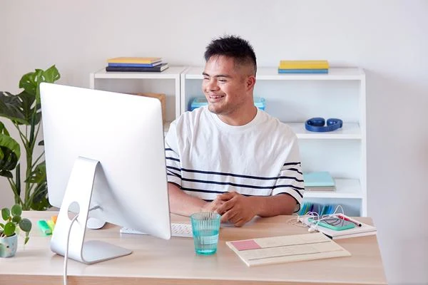 Employee smiling at his desk