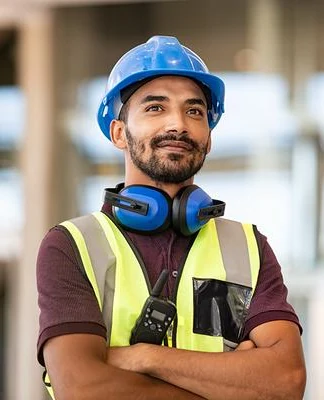 Construction worker smiling with arms crossed