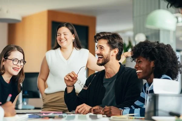 Start-up team laughing together at a meeting
