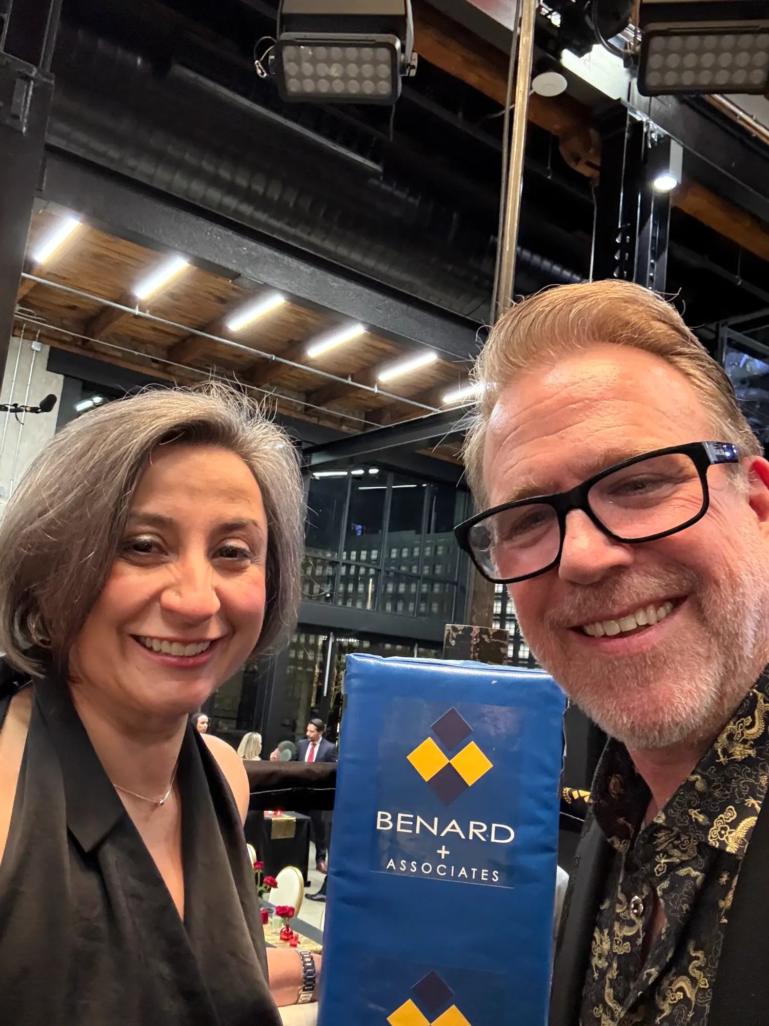 Dean & Brenda Benard posing in the boxing ring and celebrating the company's contribution to Champions for Charity