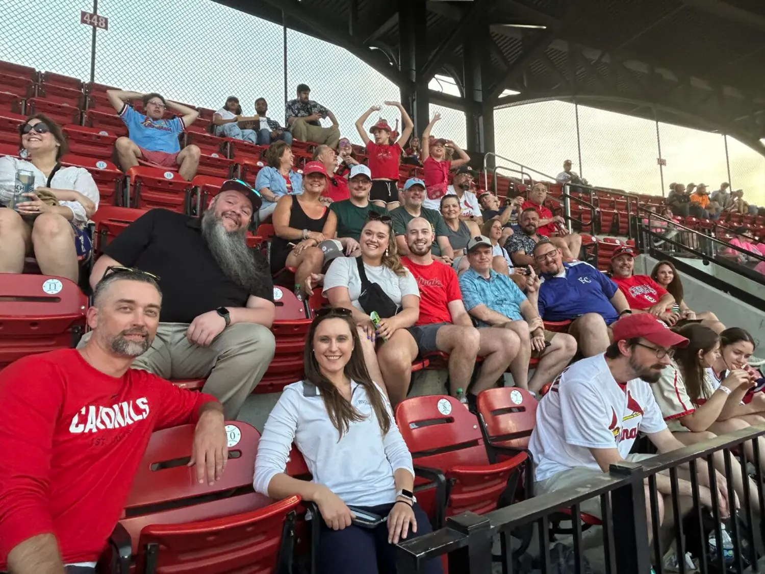 The ITS St. Louis, MO team at a summer social, cheering on the Cardinals vs. Royals game in 2025.