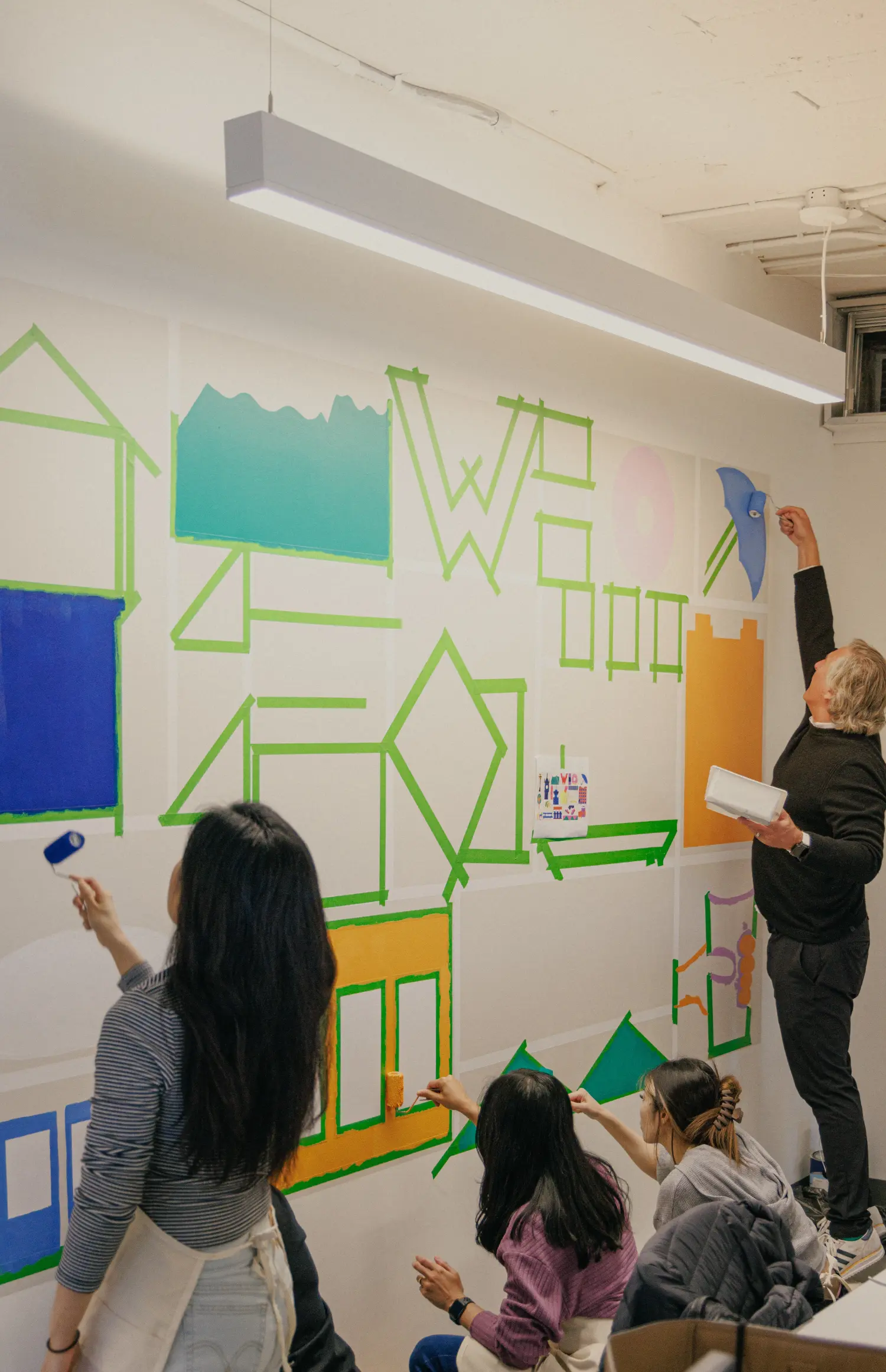 Working together to paint the new mural in our office.