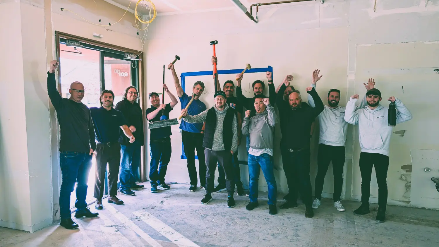 Pitching in at our new location, helping the crew bring down walls.