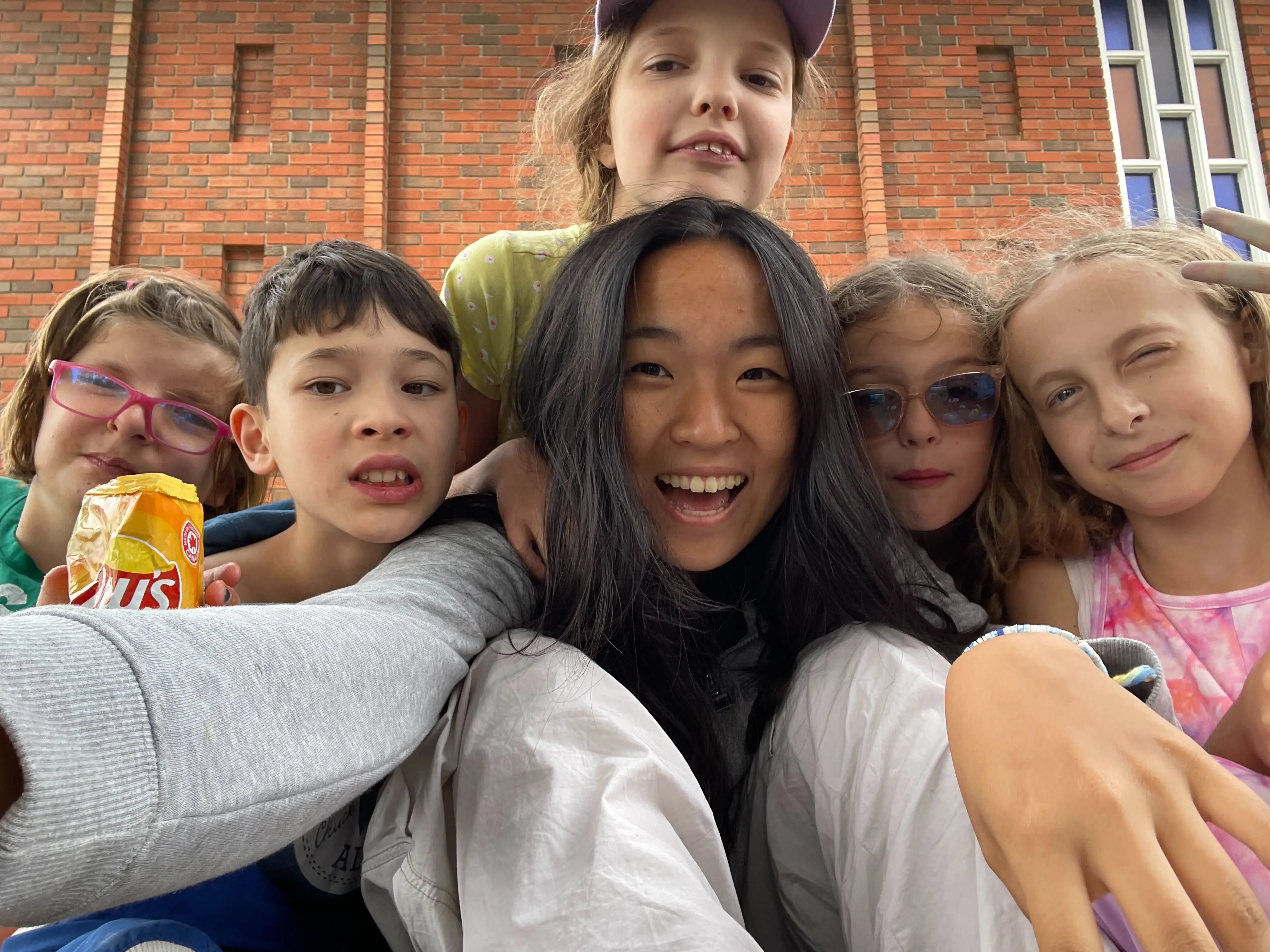A Camp Counsellor and campers taking a selfie at Camp Bonaventure