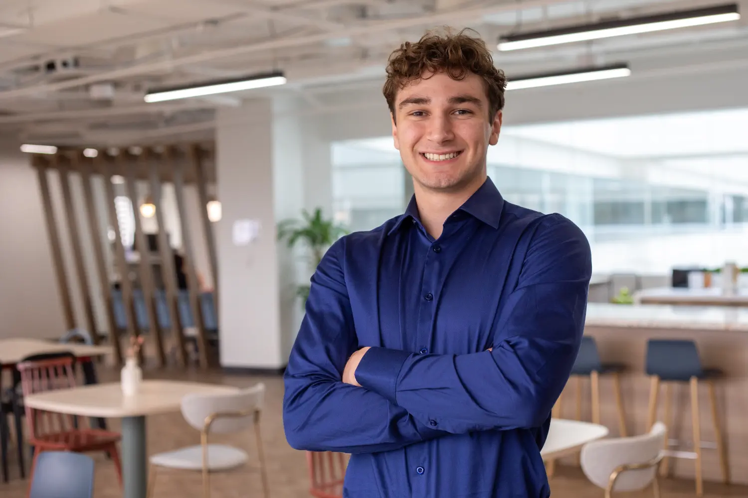 Michael Mazza, Treasury Analyst II, standing in the Toronto Hive — a welcoming space for lunch and collaboration.
