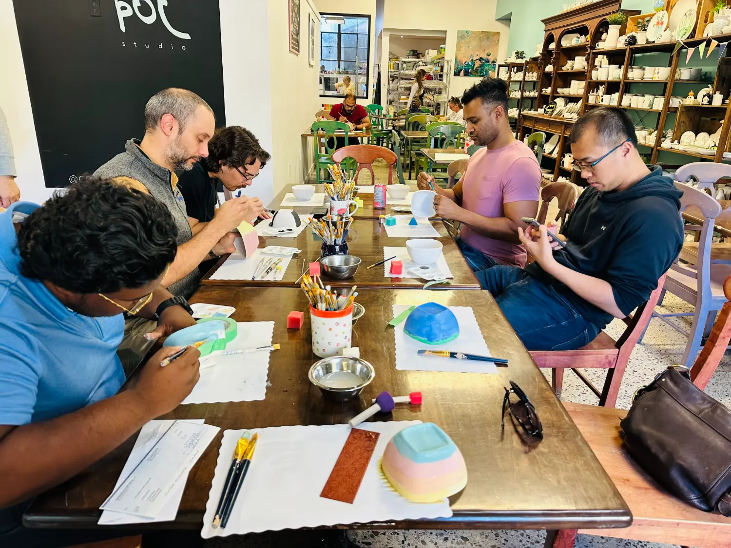 Adding colour and creativity while painting bowls for the Empty Bowls event,supporting a great cause together as a team.