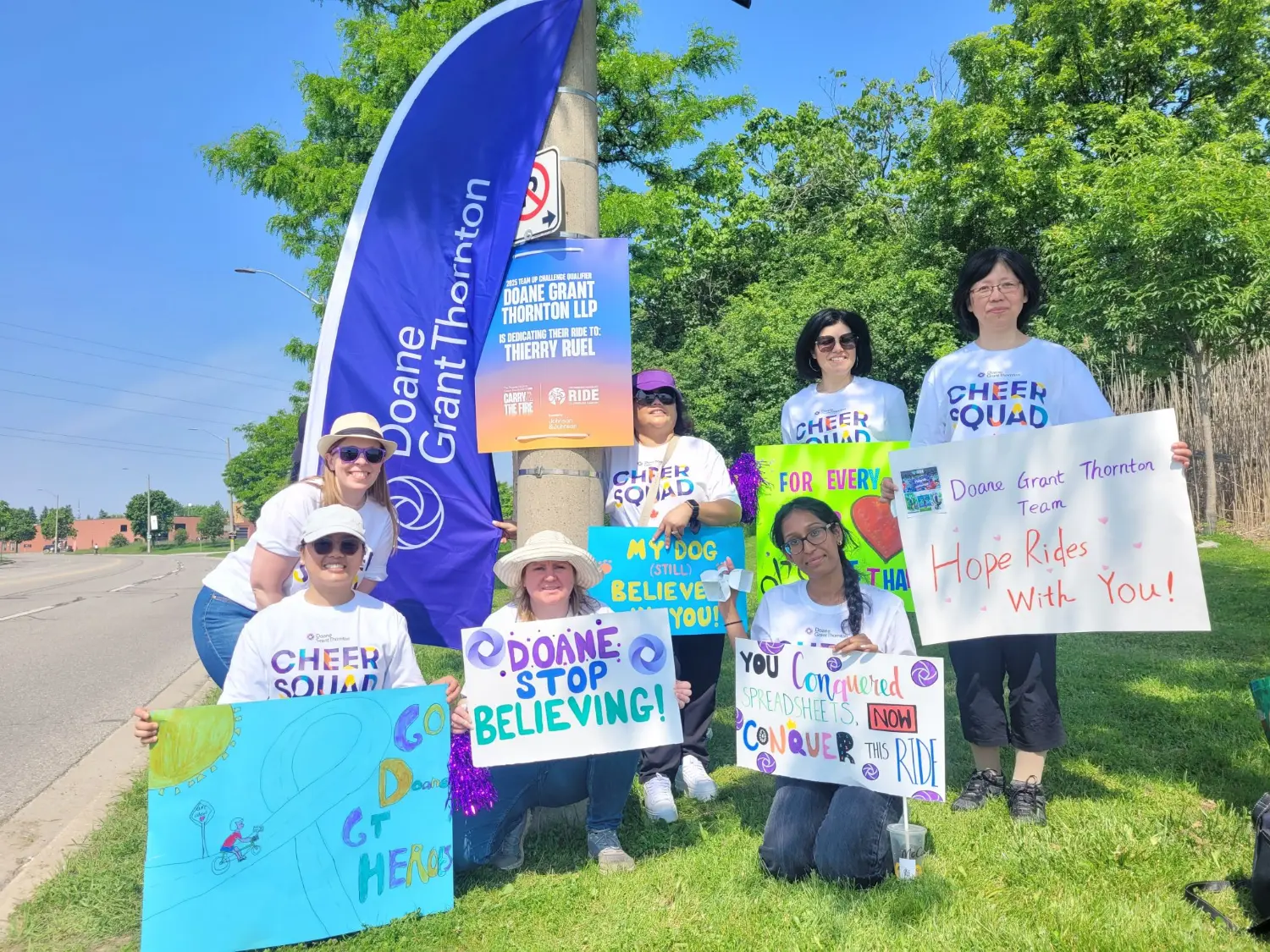 Colleagues cheer on the Doane Grant Thornton Ride to Conquer Cancer team.