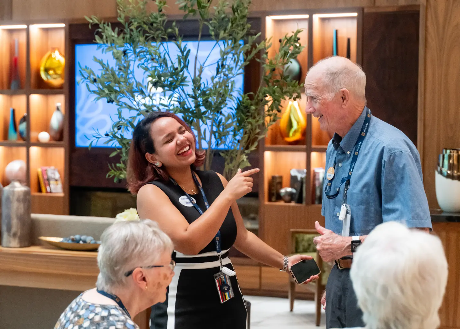 A team member and resident enjoy a laugh at the Parkland Ancaster Grand Opening in Ancaster, Ontario