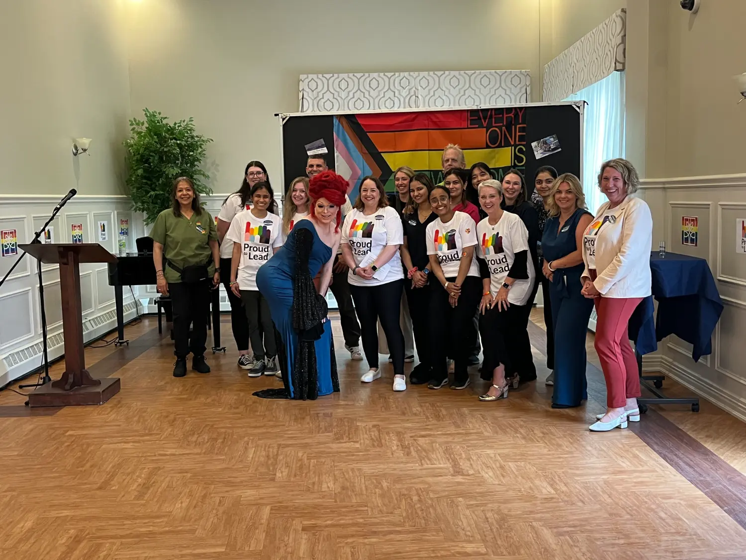 Team members pose with a local drag queen at the annual Pride celebration at Parkland Clayton Park, Nova Scotia