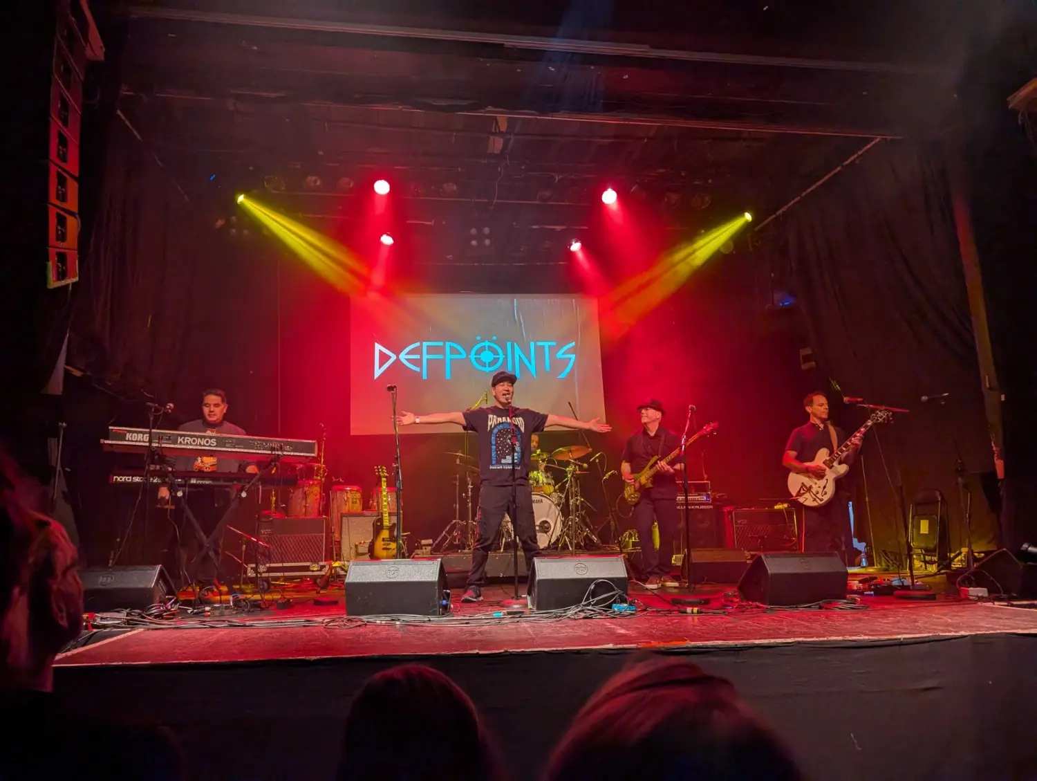 HPA employee band Defpoint, performing live in Toronto, supported by HPA staff, and locals in the audience.
