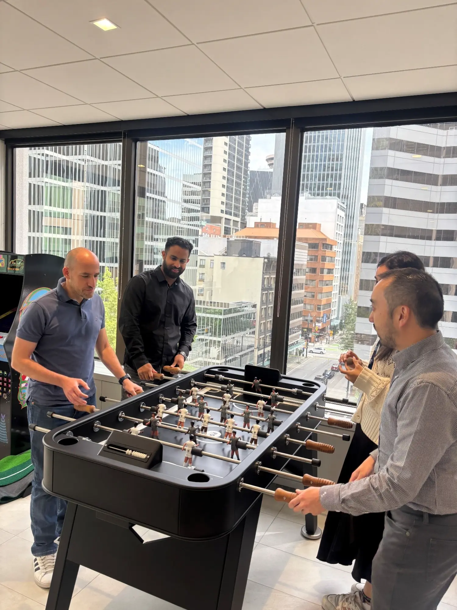 RSM Canada employees taking a break in the office lounge/games area.