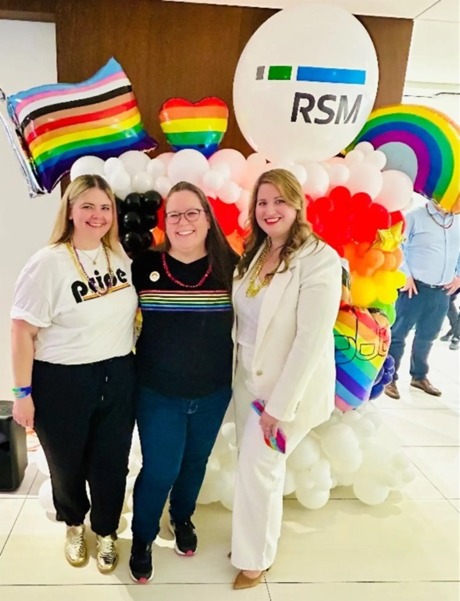 RSM Canada Pride employee network group members hosting an in - office Pride celebration.