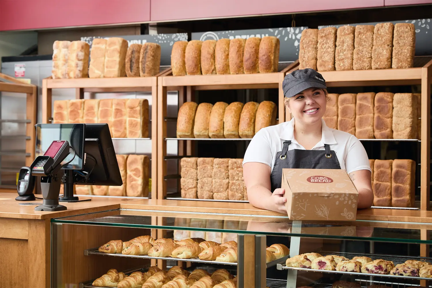 Beaming with joy and passion, the sales associate presents the customer's order with great pride.