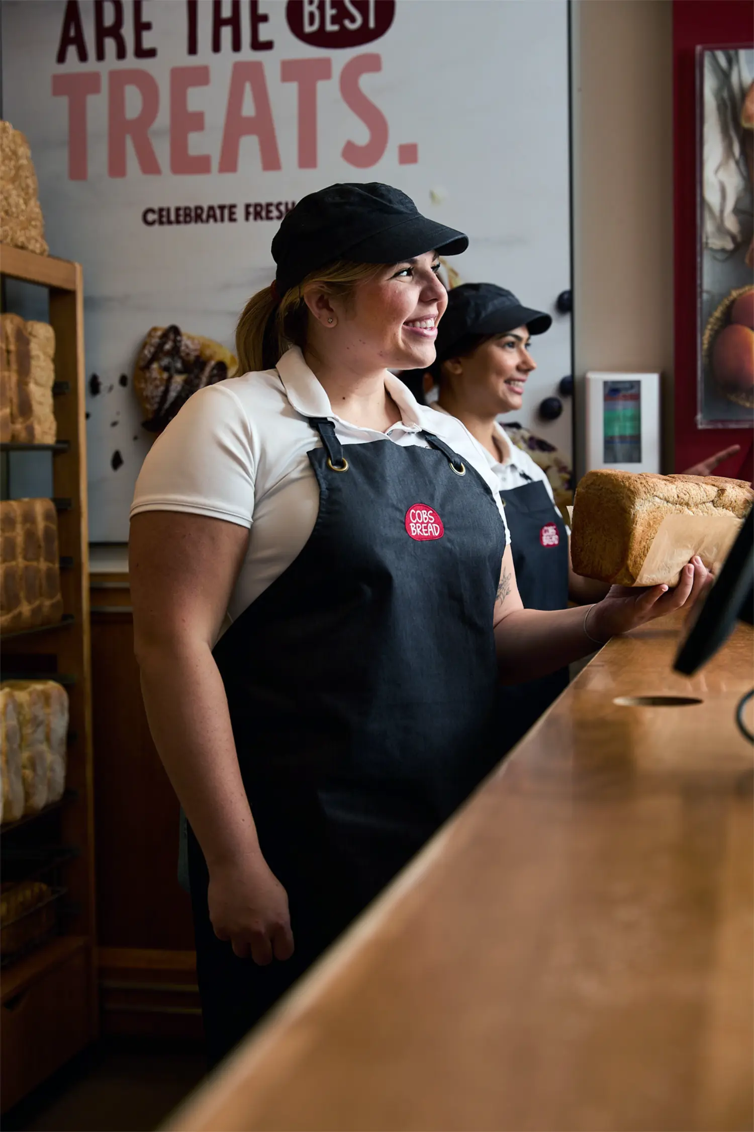 The sales associate provides personable customer service with big smiles on their hardworking, gracious faces.