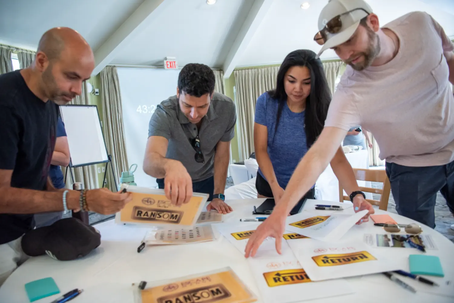 SW&A team members work together to crack a puzzle as part of our team building summer offsite