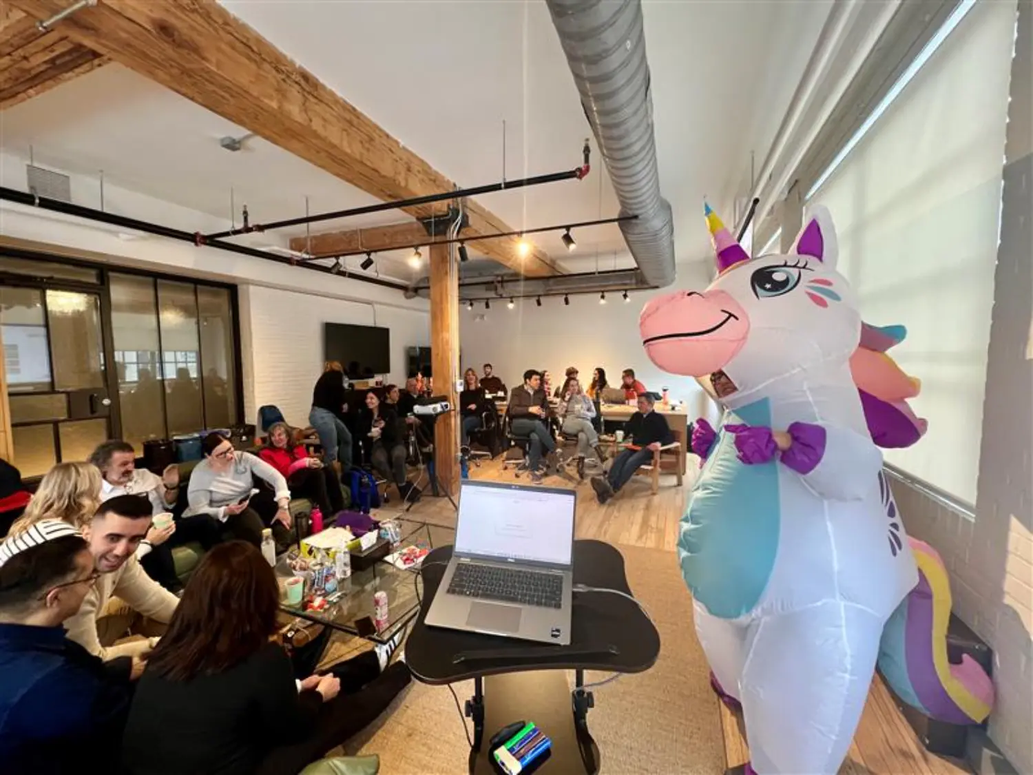 Our Director presents in an inflatable unicorn costume to help the team beat the winter blues