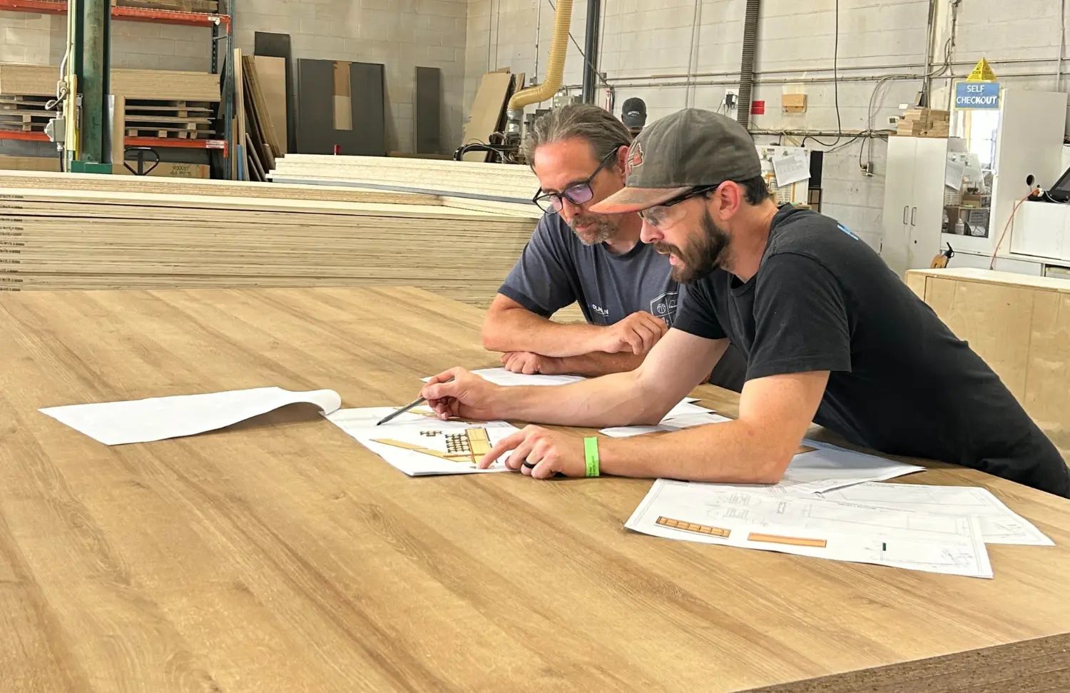 The fine work of our shop leadership collaborating on a detailed drawing to bring exceptional craftsmanship to life.