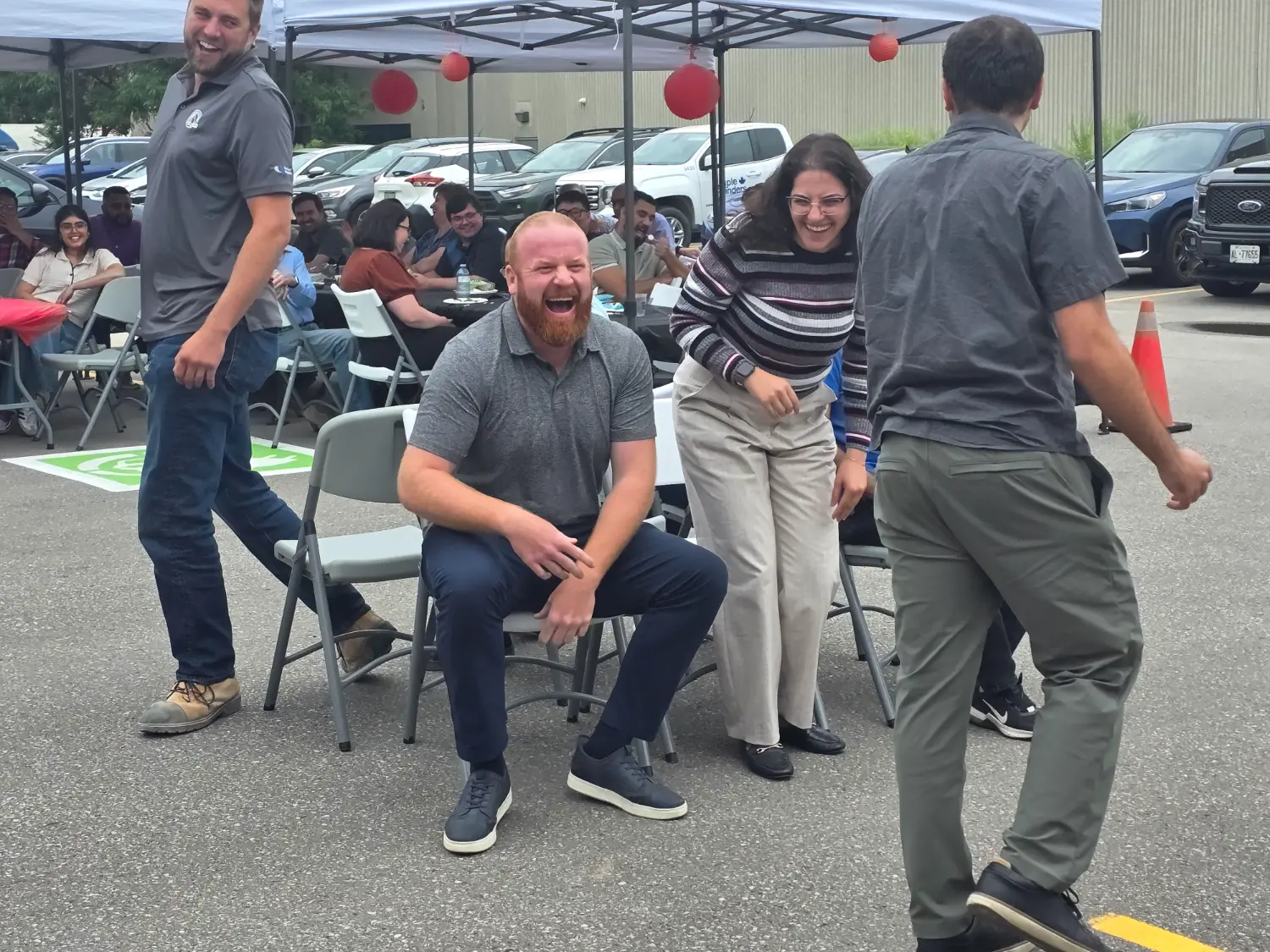 All smiles playing musical chairs at one of our summer 2025 BBQs!