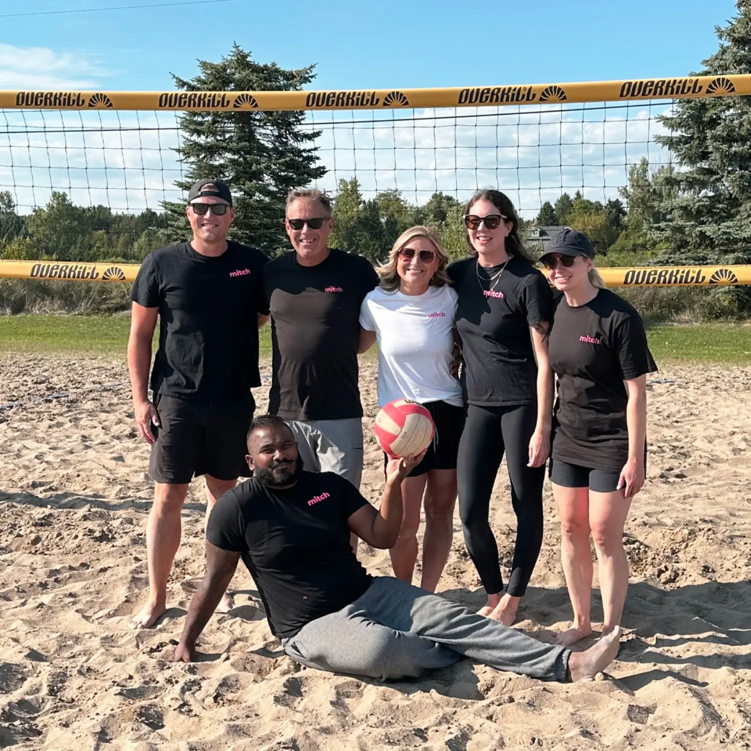 Soaking in the sun playing beach volleyball.