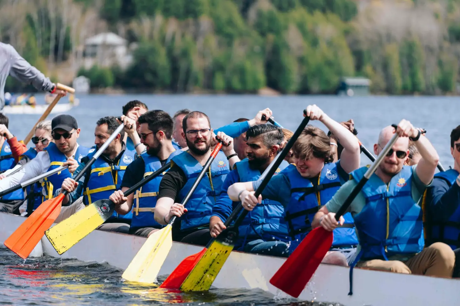The BlueCat team racing to the finish line in a dragon boat challenge in Muskoka during our Kick Off.