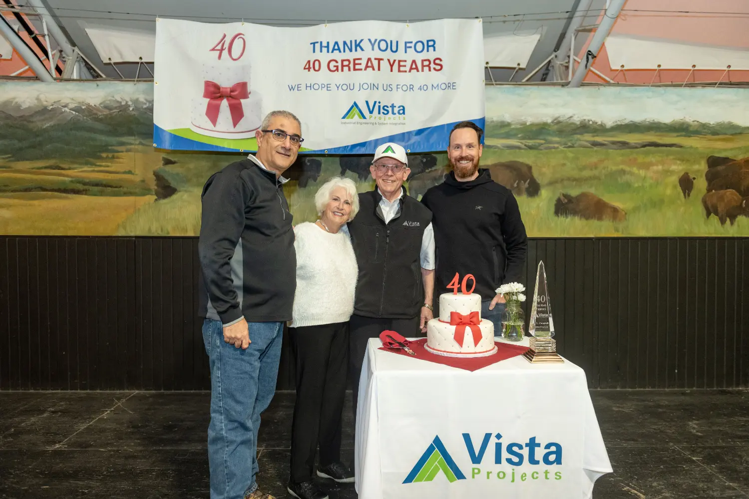 Founders, Alex and Wendy Campbell, pause for a photo with current CEO Scott Mussbacher and previous CEO, Bashar Hussien.
