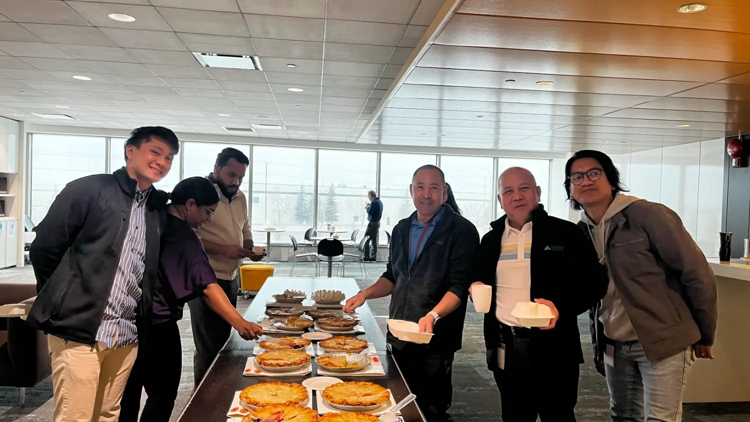 Vista Projects colleagues celebrate Pi Day at the office with delicious pies from a local bakery. 