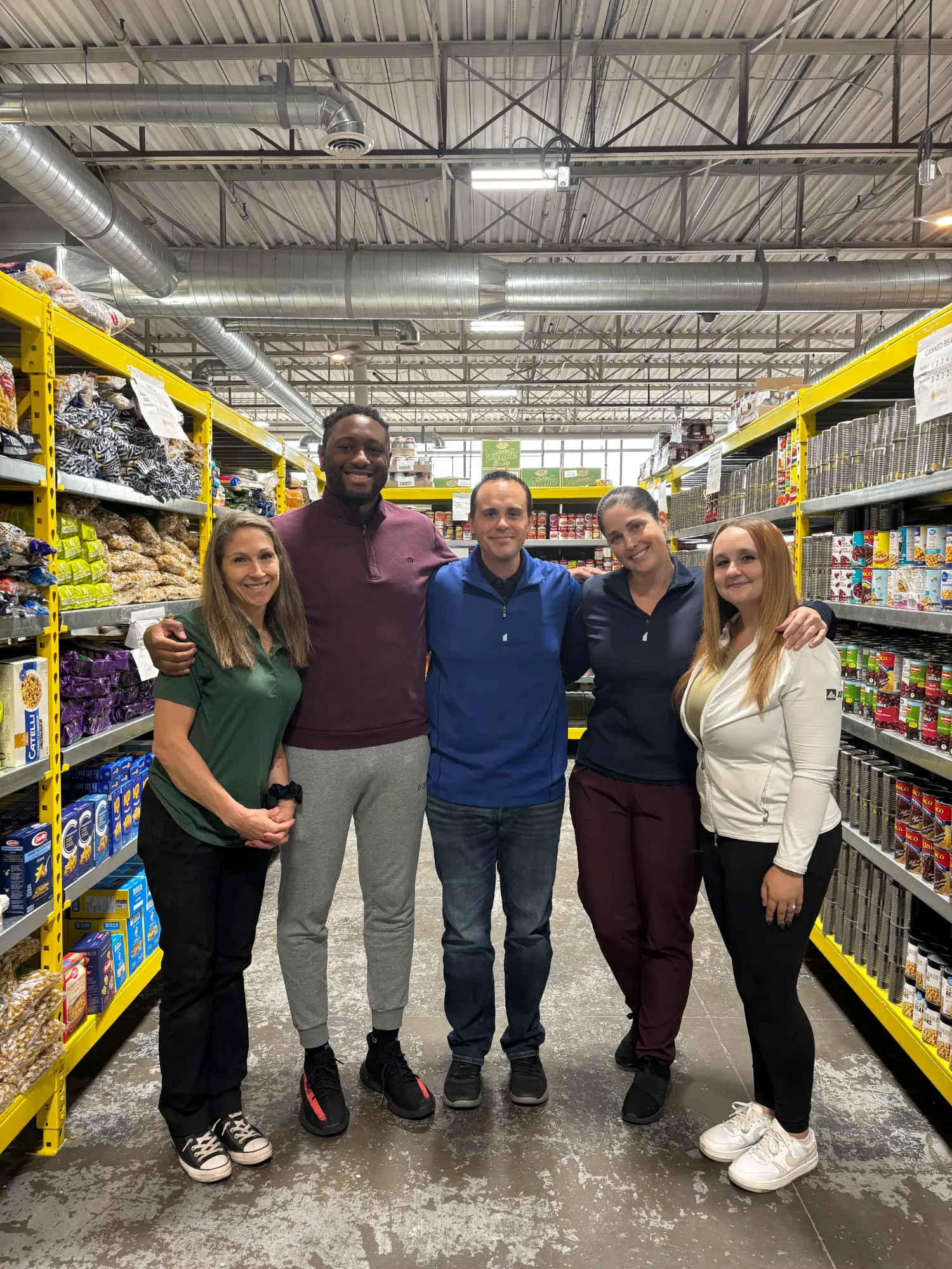 Members of the AD Canada team lending a hand, volunteering at Seva Food Bank.