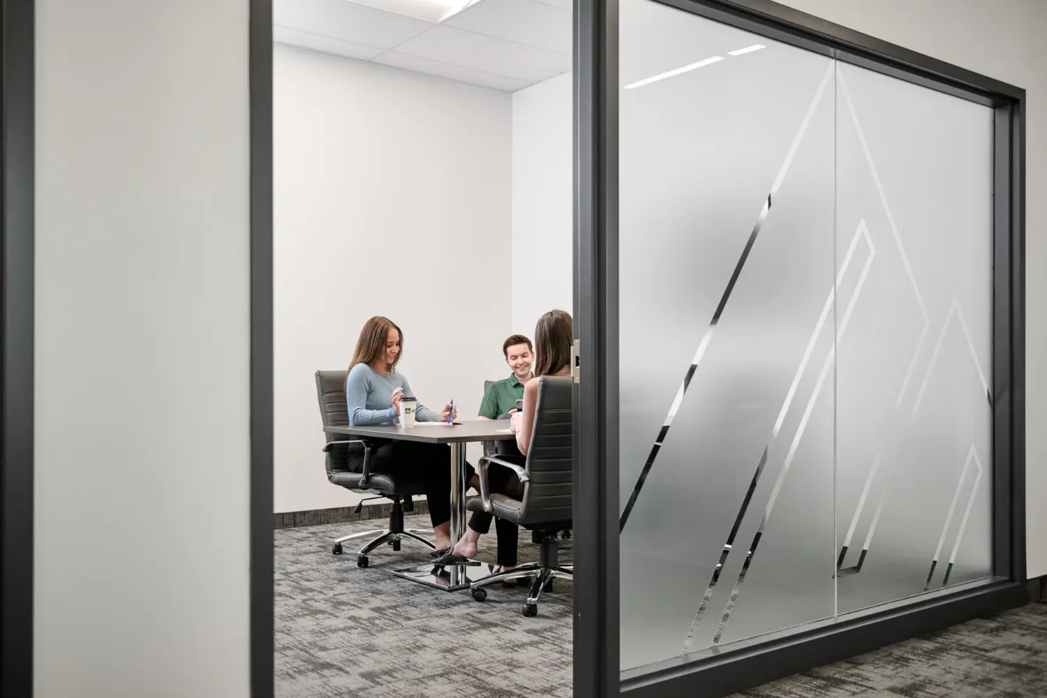 A moment of teamwork and conversation inside an AD Canada meeting room.