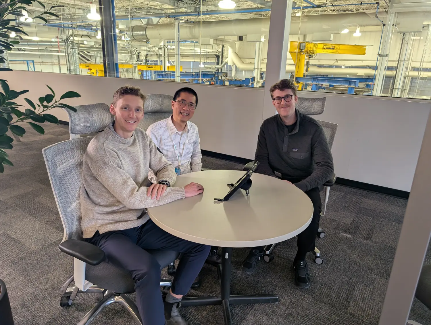 Team members meeting while they overlook our demonstration unit from above.