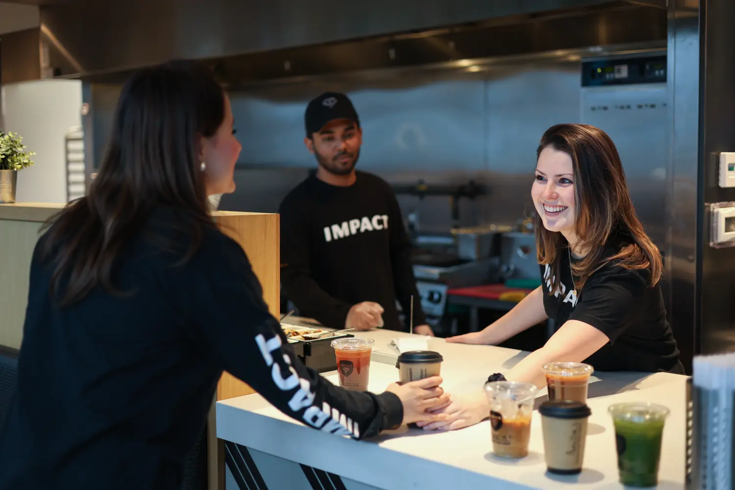 Manager hands over Coffee order to server