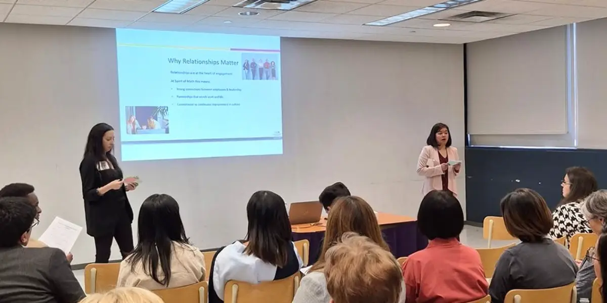 Colleagues leading a session on workplace relationships, capturing our commitment to a supportive culture.