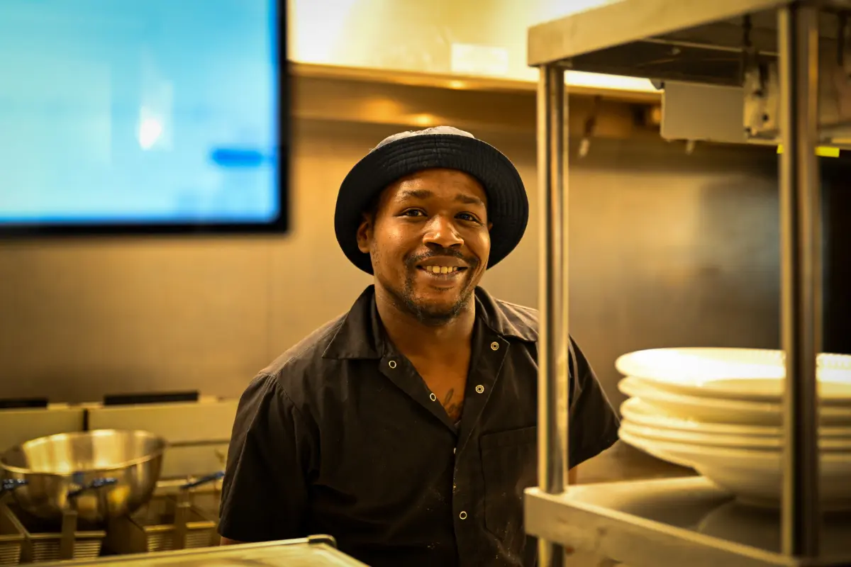 Culinary team member in peak Canada Day service—precision, teamwork & commitment to elevated farm-to-table execution.