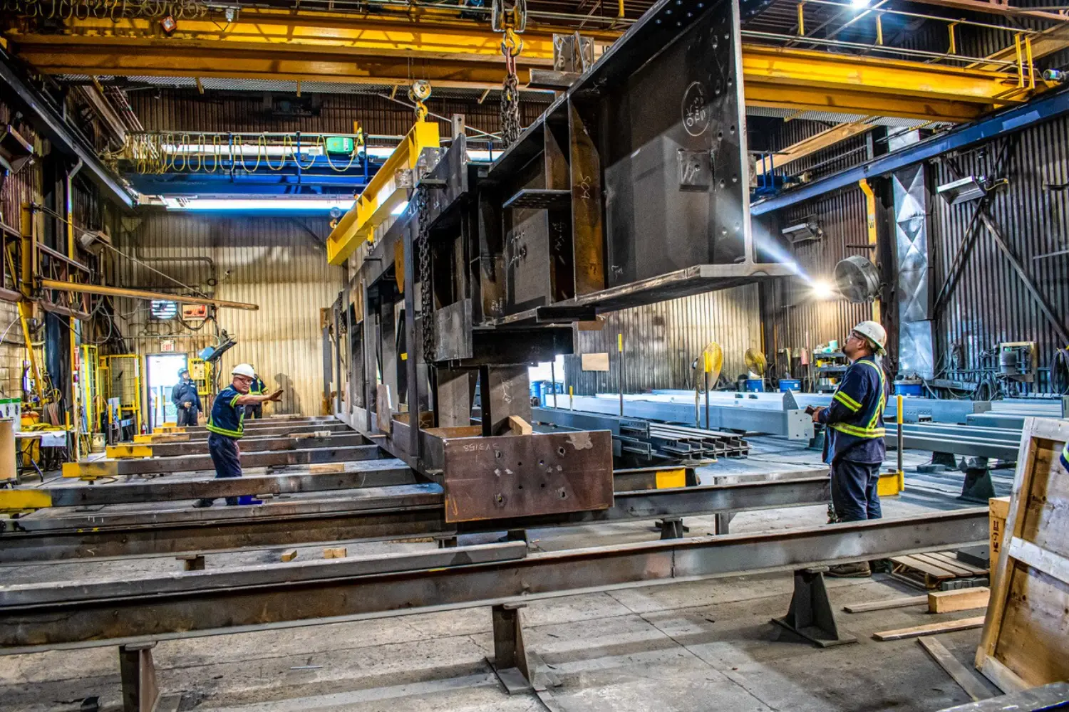 Benson Steel plant staff moving large structural steel with our indoor cranes for continuation of its process.