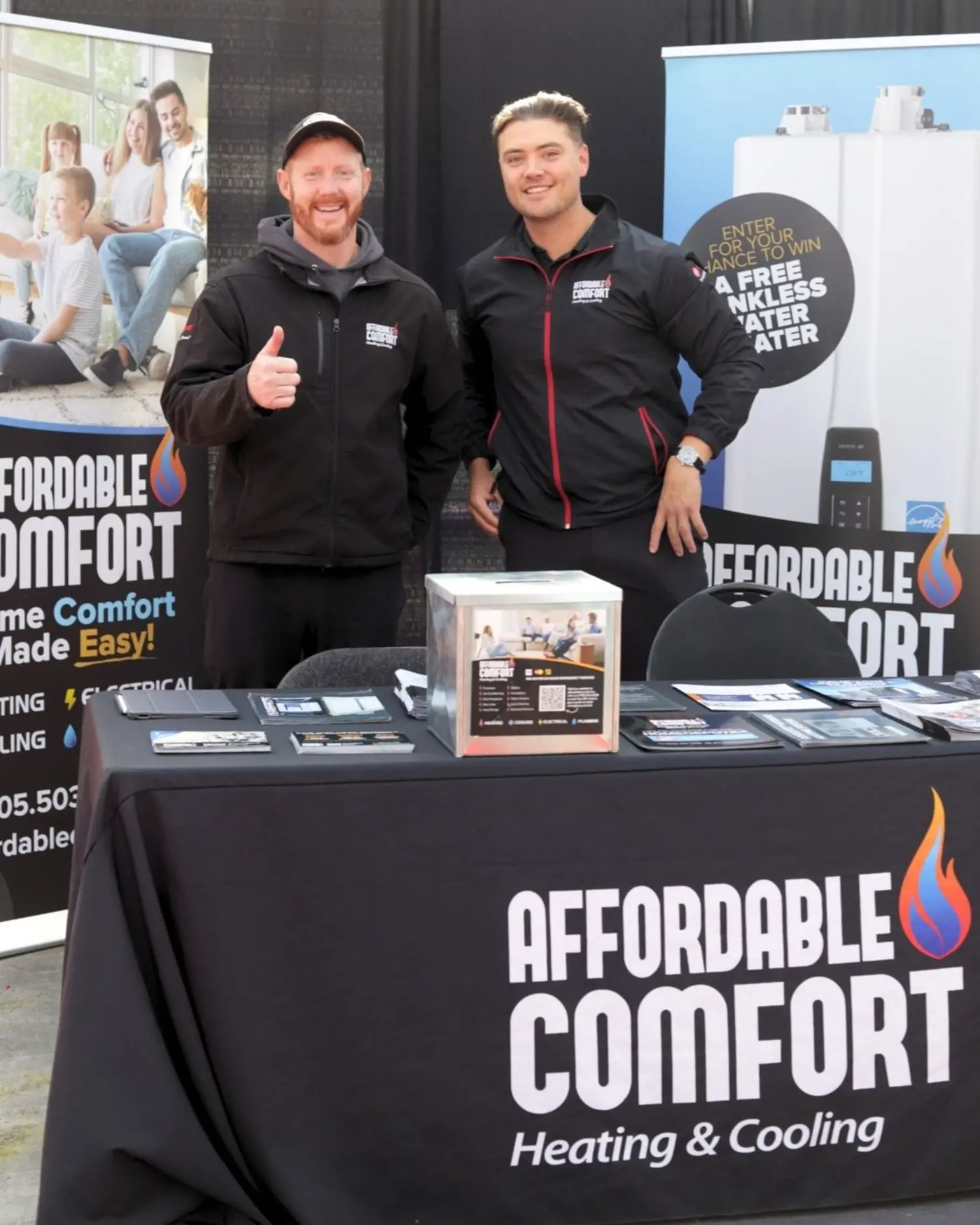 Team members representing Affordable Comfort at a community event.