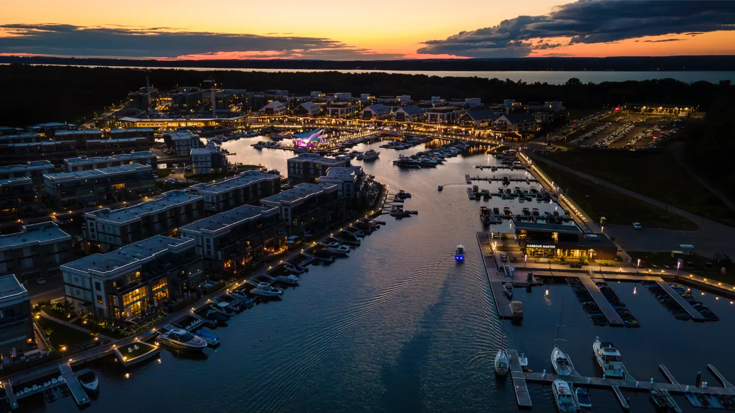 Golden sunset views over Friday Harbour Marina, where sparkling waters and vibrant lights shine bright.