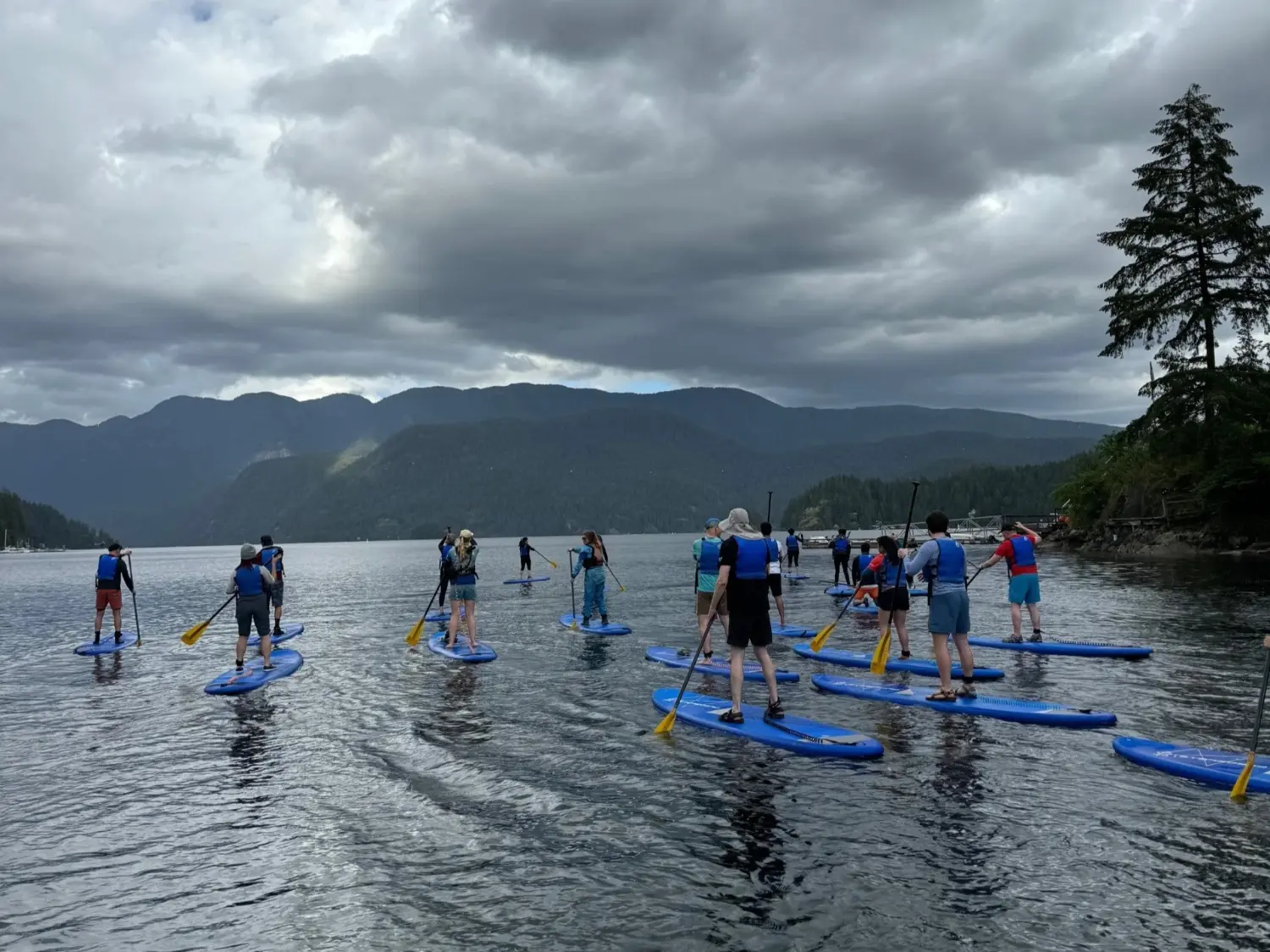 Supporting well‑being through Life Well Lived activities like stand‑up paddleboarding.