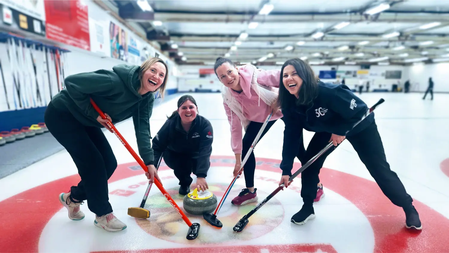 Team members supporting the local curling club - building stronger communities, one stone at a time!