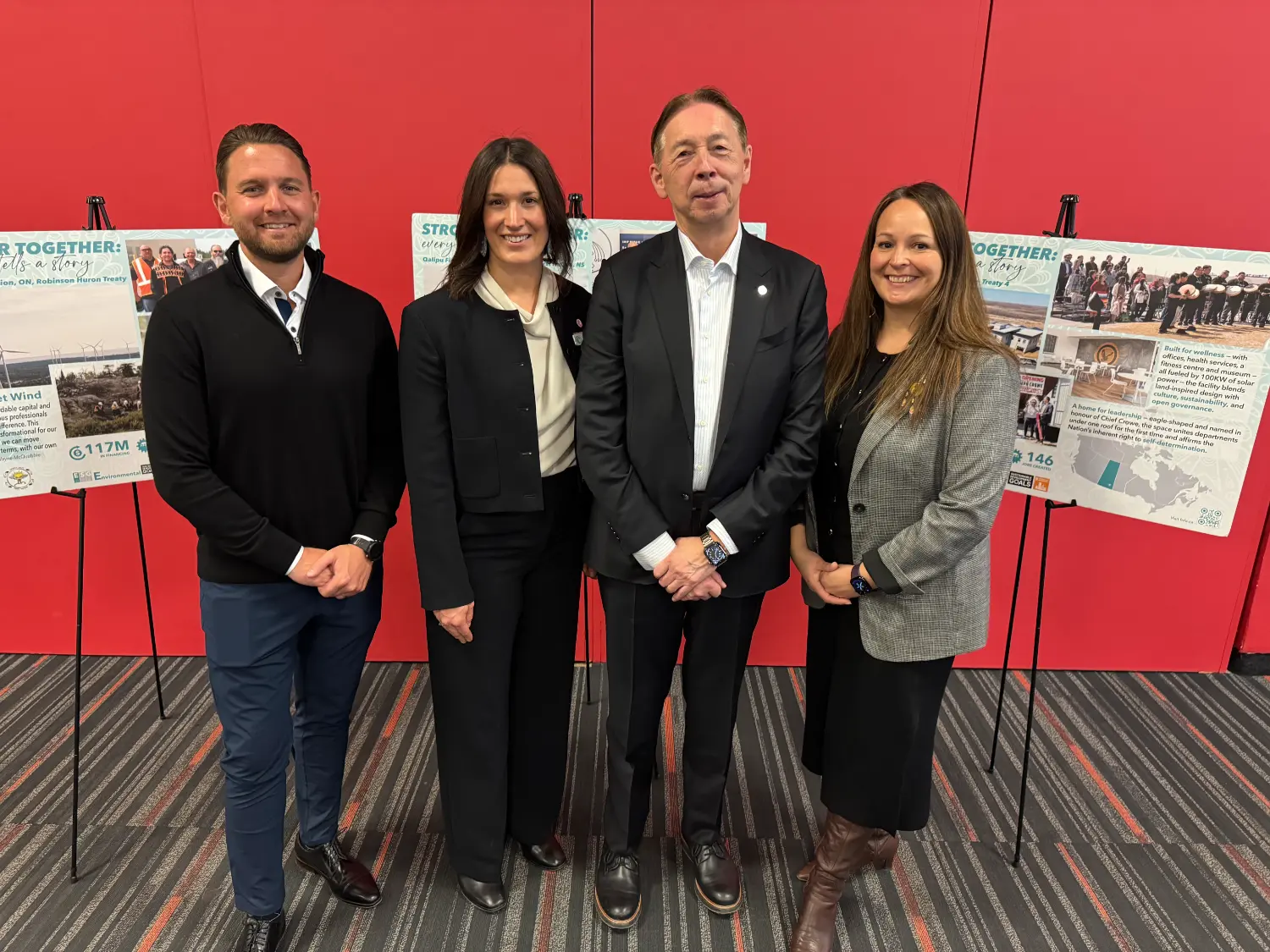 FNFA at AFOA Canada, FNFA team stand in front of community case studies showcasing First Nations projects.