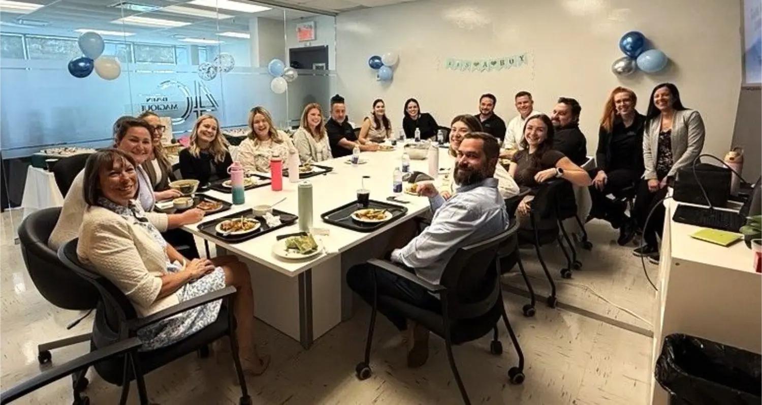 Team celebrating an employee's departure for maternity leave.