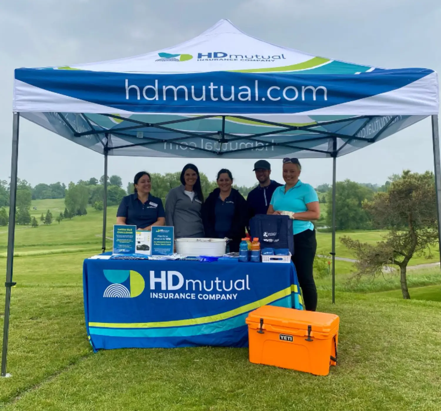 Connecting with valued broker partners at a community golf tournament.
