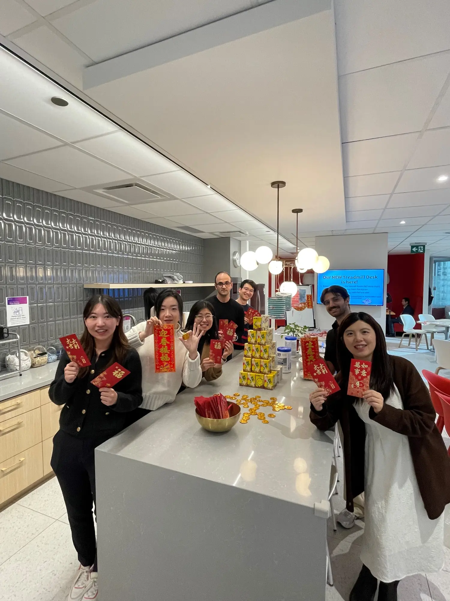 Group photos of employees celebrating lunar new year in the Toronto office.