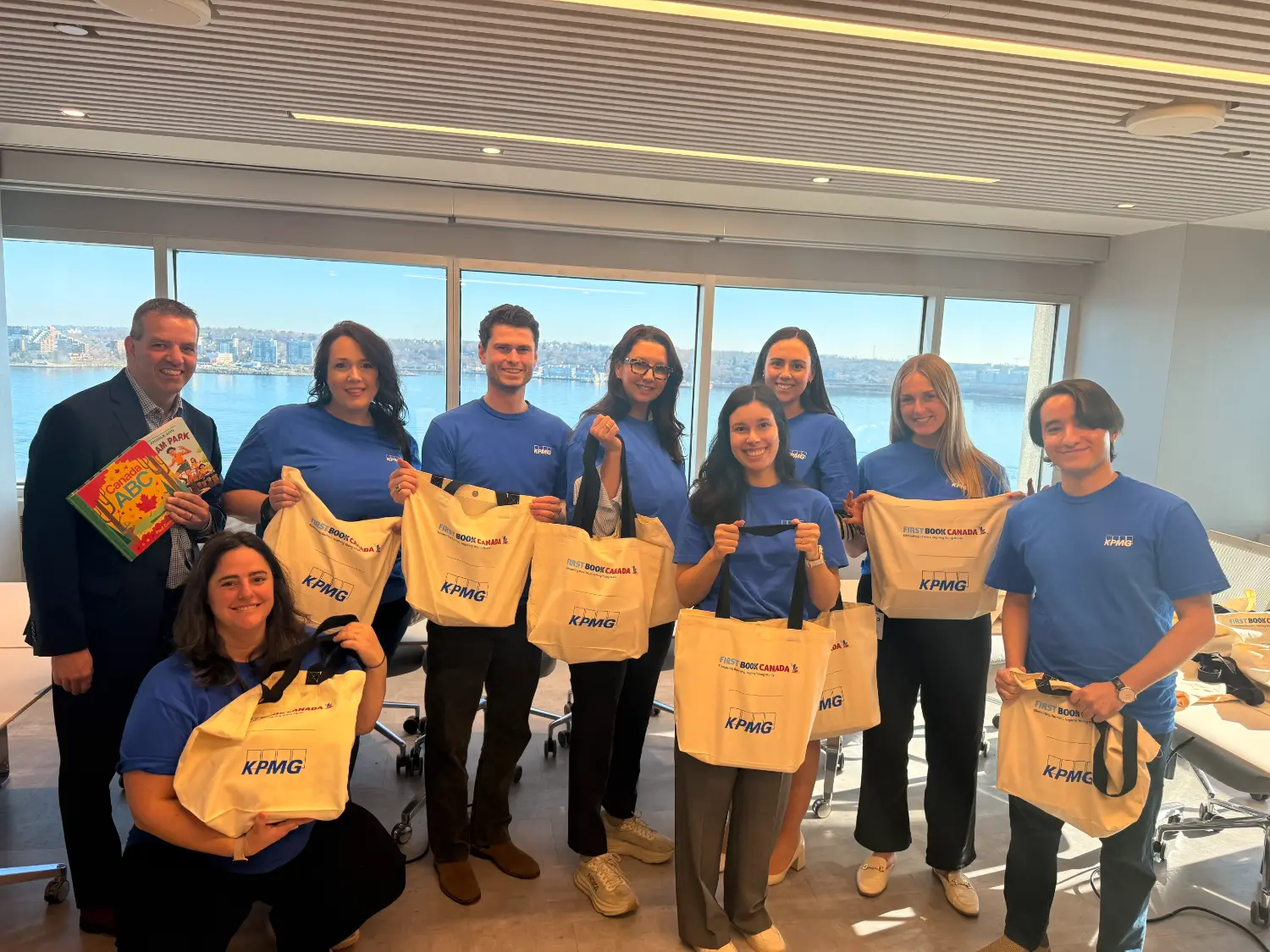 Employee volunteers in Halifax sorting book bags for distribution to local elementary school students