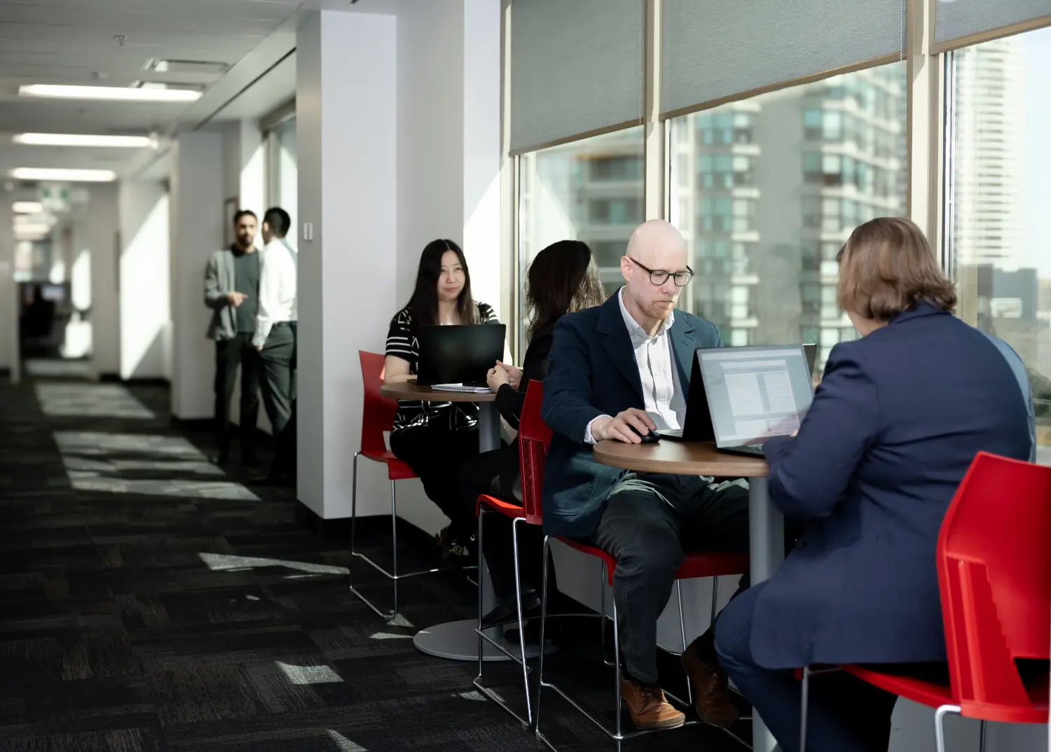 OMVIC team members collaborate in an open workspace that supports productivity and encourages informal interaction.