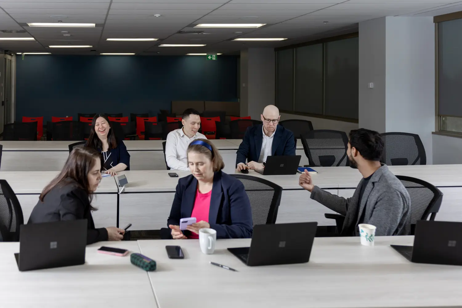 OMVIC staff in a dynamic team setting, sharing insights and building strategies to drive consumer protection forward.