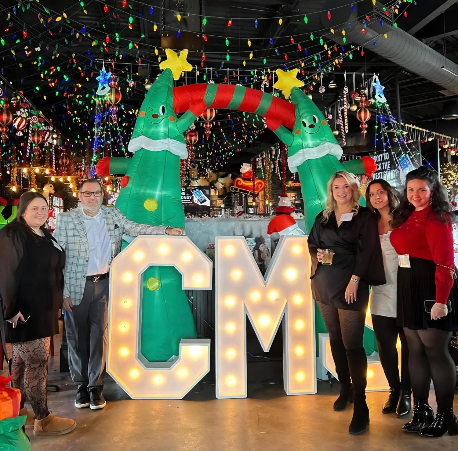 The CMS Group events & social committee at the 2025 annual holiday party for employees.