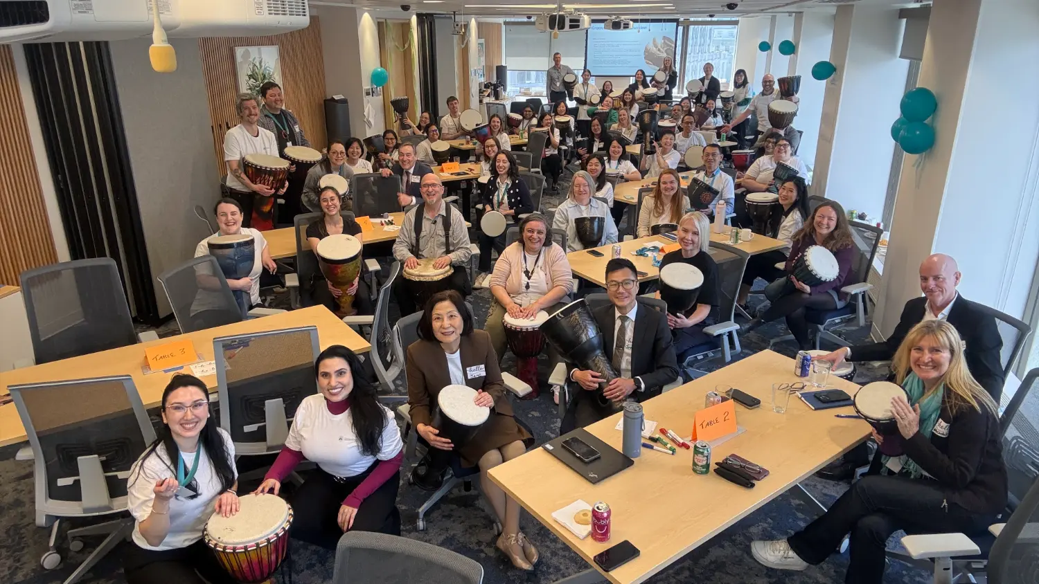 Company All-Staff meeting with drumming circle