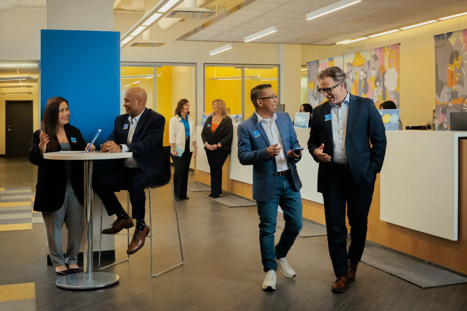 Team members connecting and collaborating inside a bright, modern branch office.