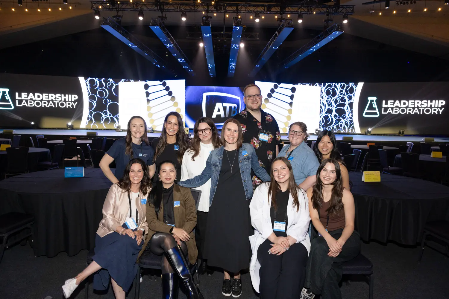 A group of team members gathering on stage at the ATB Leadership conference.