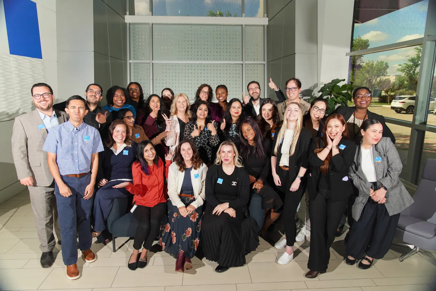 A large group of team members posing together for a fun team photo.